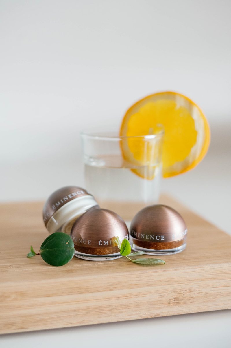 Éminence eye creams styled with fresh citrus